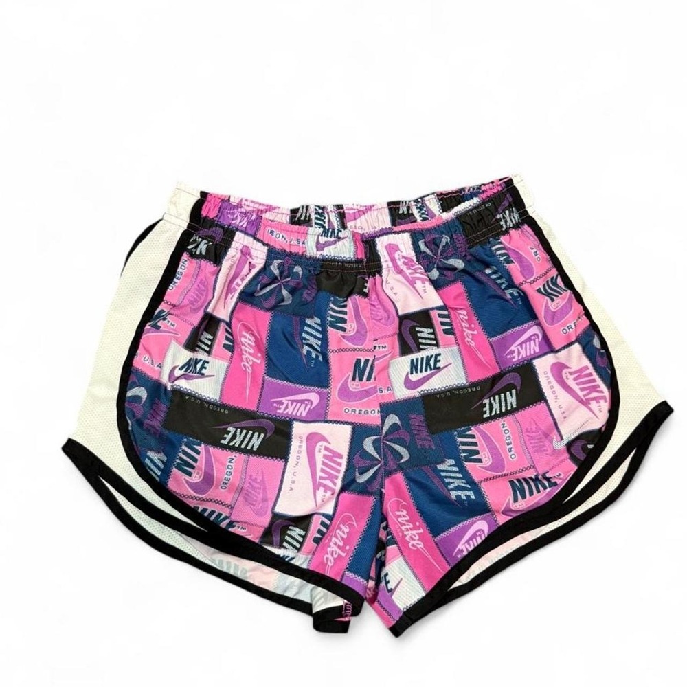 Women nike pink, purple, and white shorts with repeating Nike logo and text